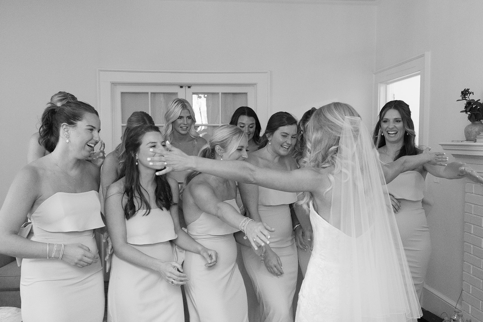 bride hugging her bridesmaids after their first look, this is also such a fun detail in a wedding weekend timeline!