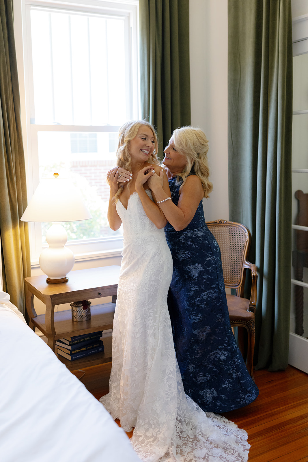 Bride and her mother sharing a sweet moment while fastening a bracelet before the wedding ceremony
