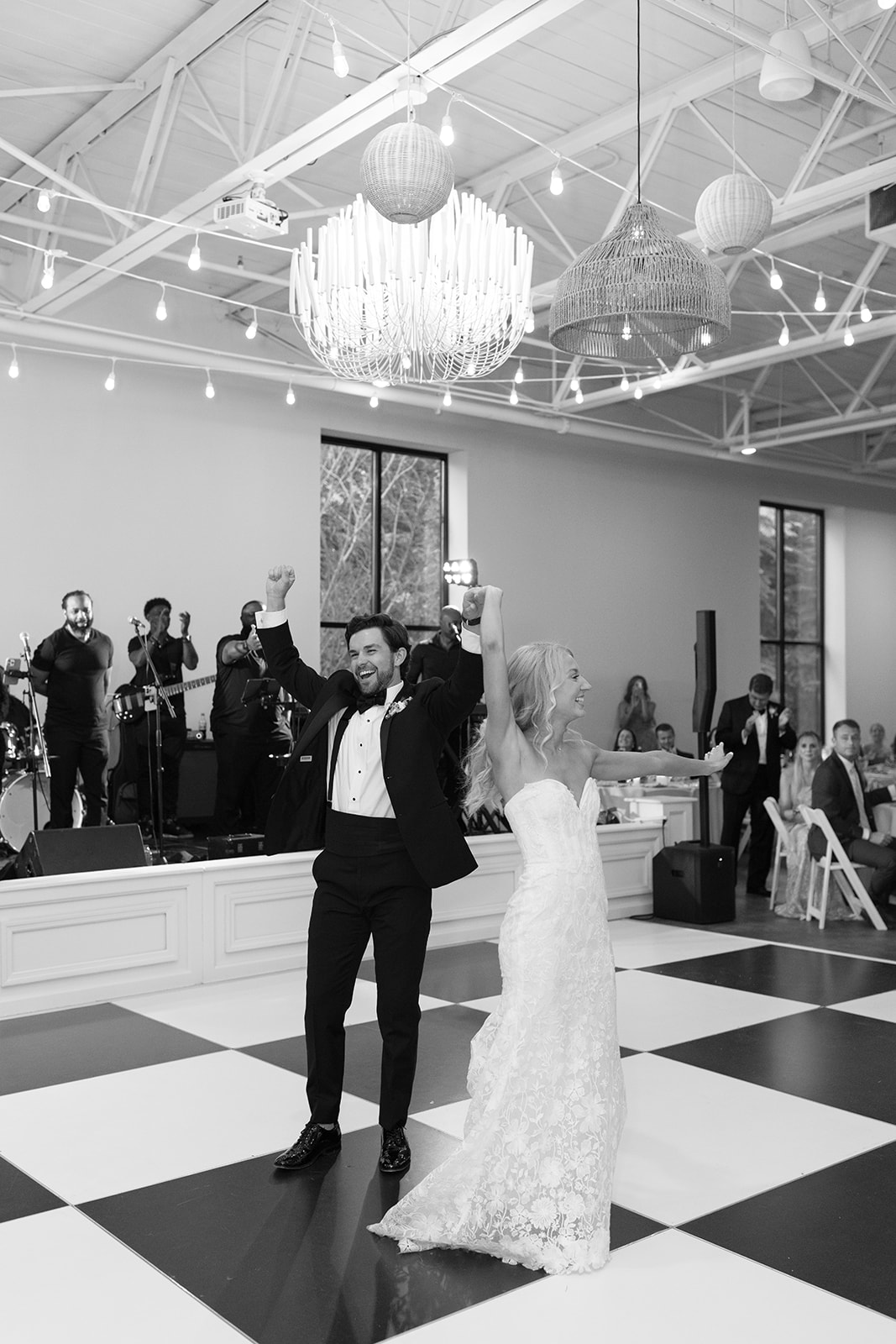bride and groom dancing on the checkered floor at their reception