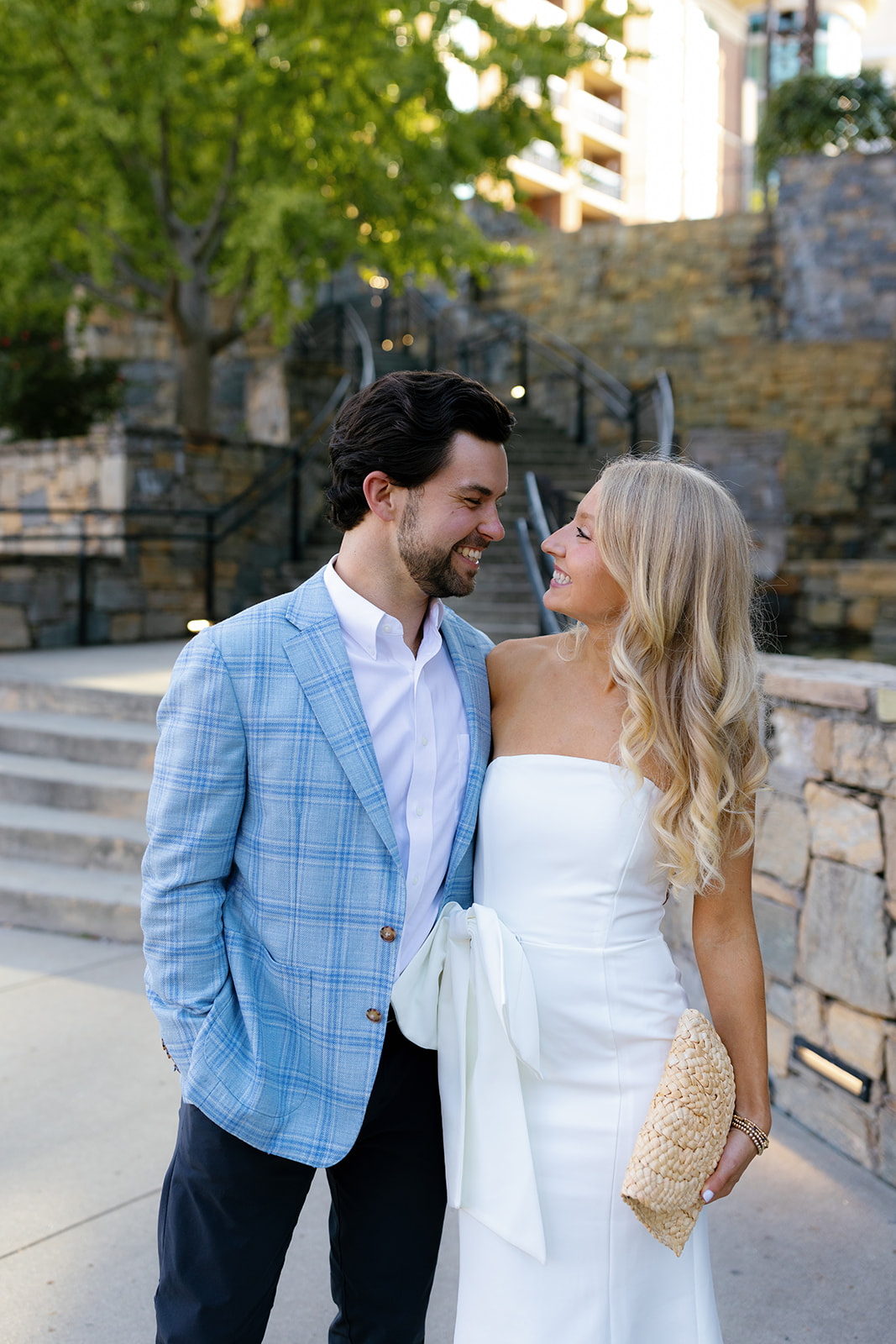 Bride and groom laughing together in downtown Greenville, SC before their rehearsal dinner inside their Wedding Weekend Timeline.