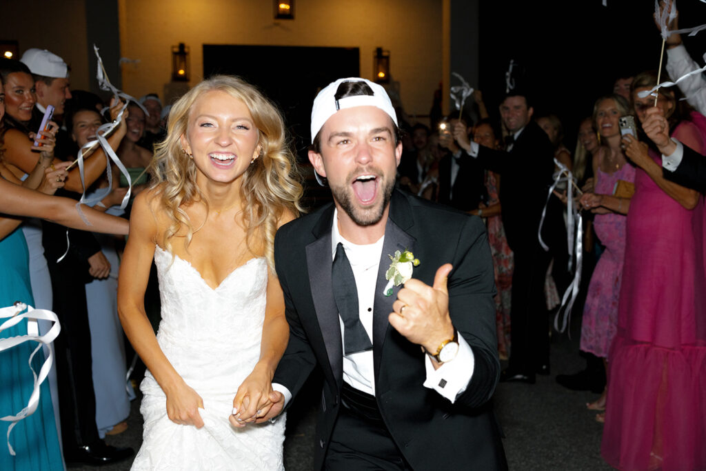 Excited bride and groom leave their wedding in south carolina, a wedding exit is so much fun to add into a Wedding Weekend Timeline.