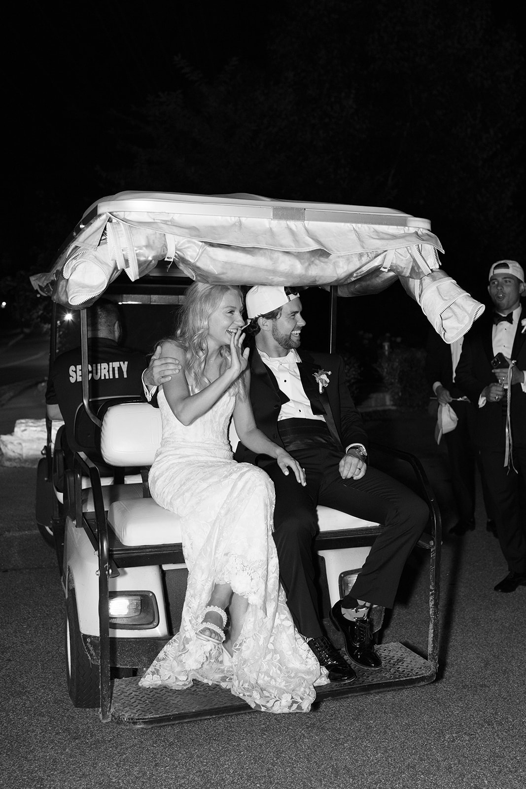 the bride and groom riding off in a golf cart for the the final detail of their wedding weekend timeline