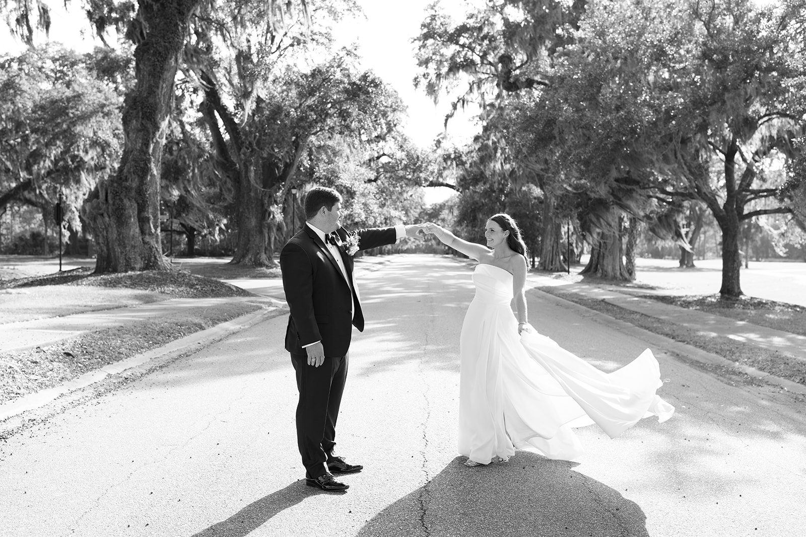 Brooks twirls Mills in the middle of a live oak-lined street during golden hour portraits.