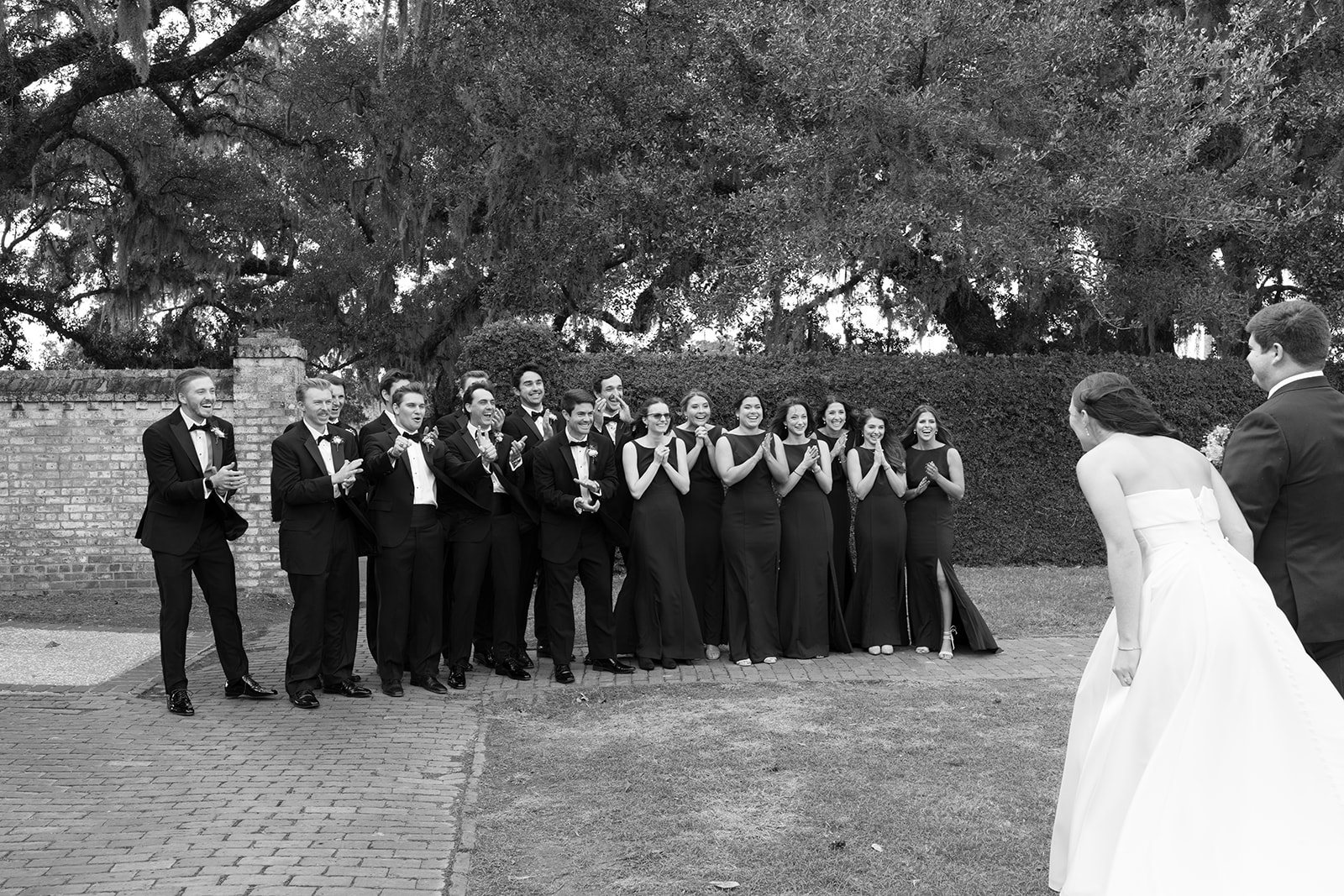 the wedding couple standing in front of the wedding party 