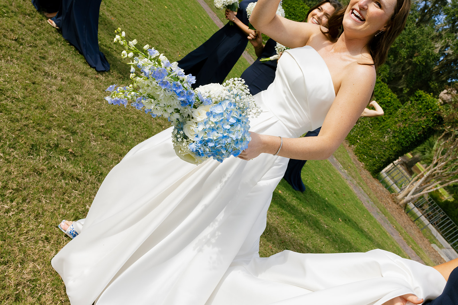 the bride holding her blue and white bouquet 