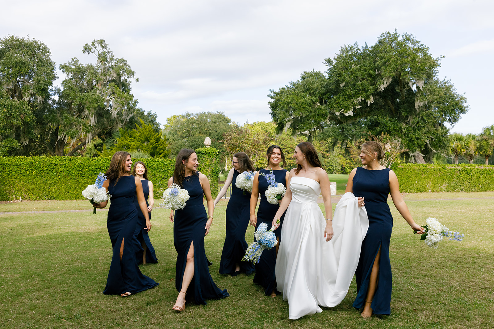 the bride and bridesmaids walking together 