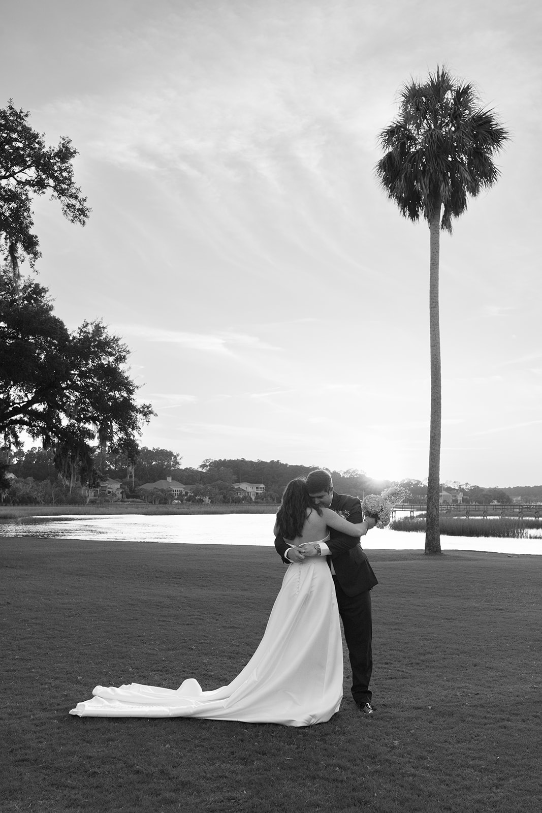 The couple shares a sweet embrace by the water.