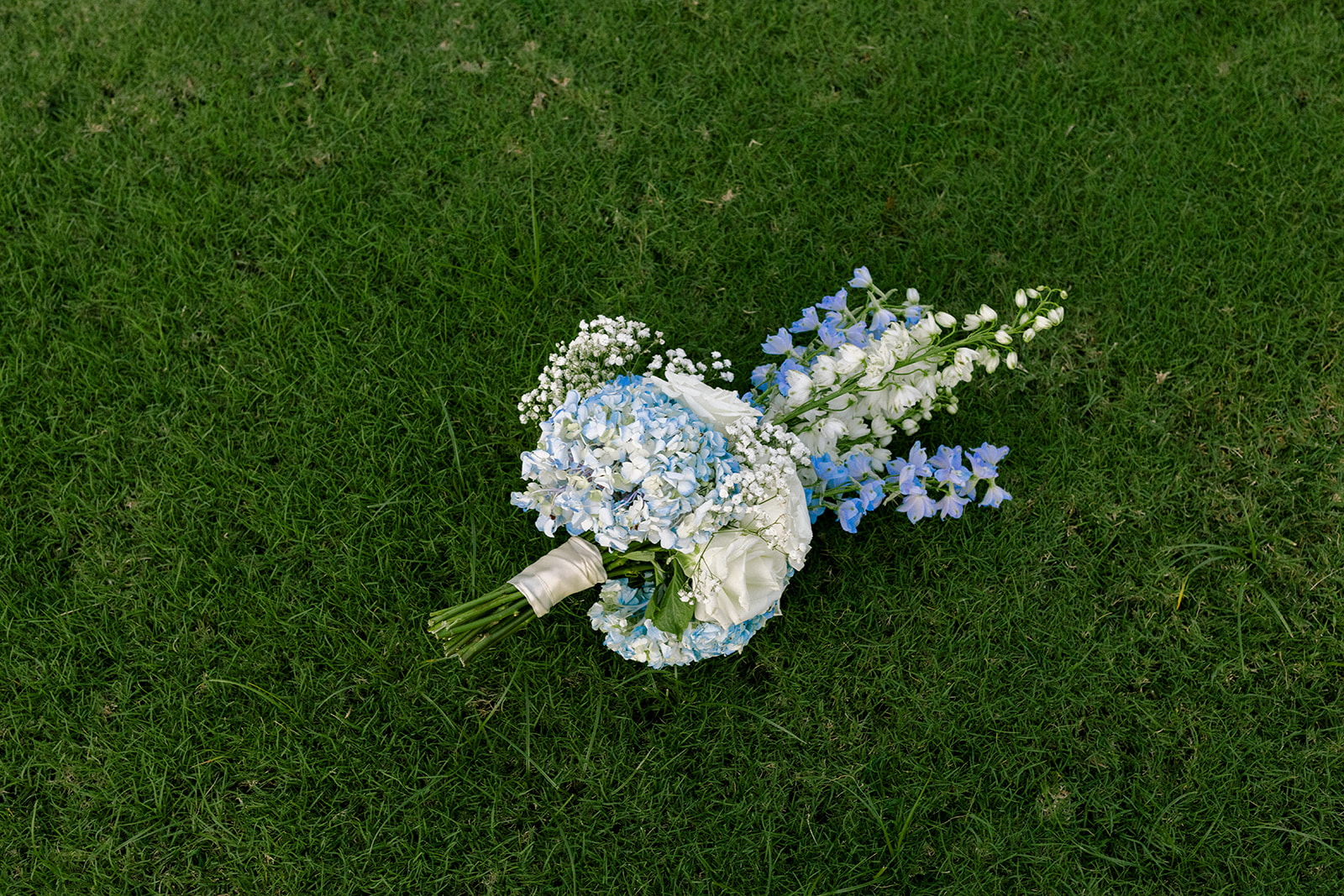 bride's bouquet laying in the grass 