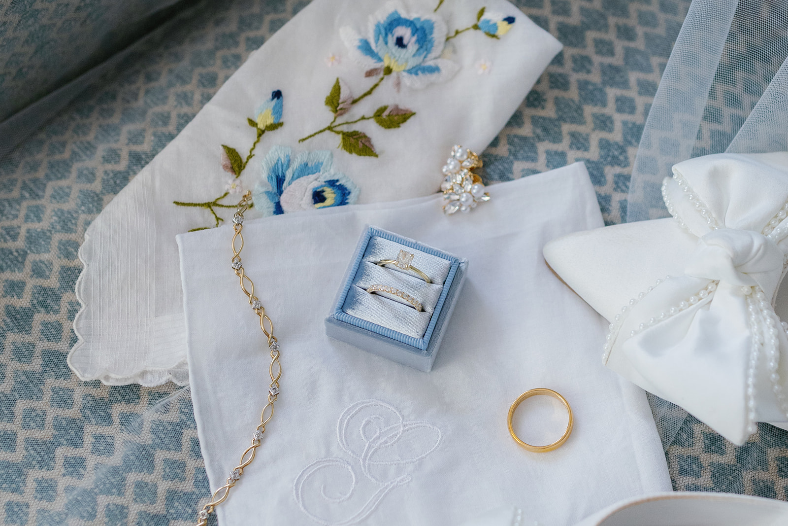 Bridal details include heirloom jewelry, embroidered handkerchief, and white shoes with pearl bows.