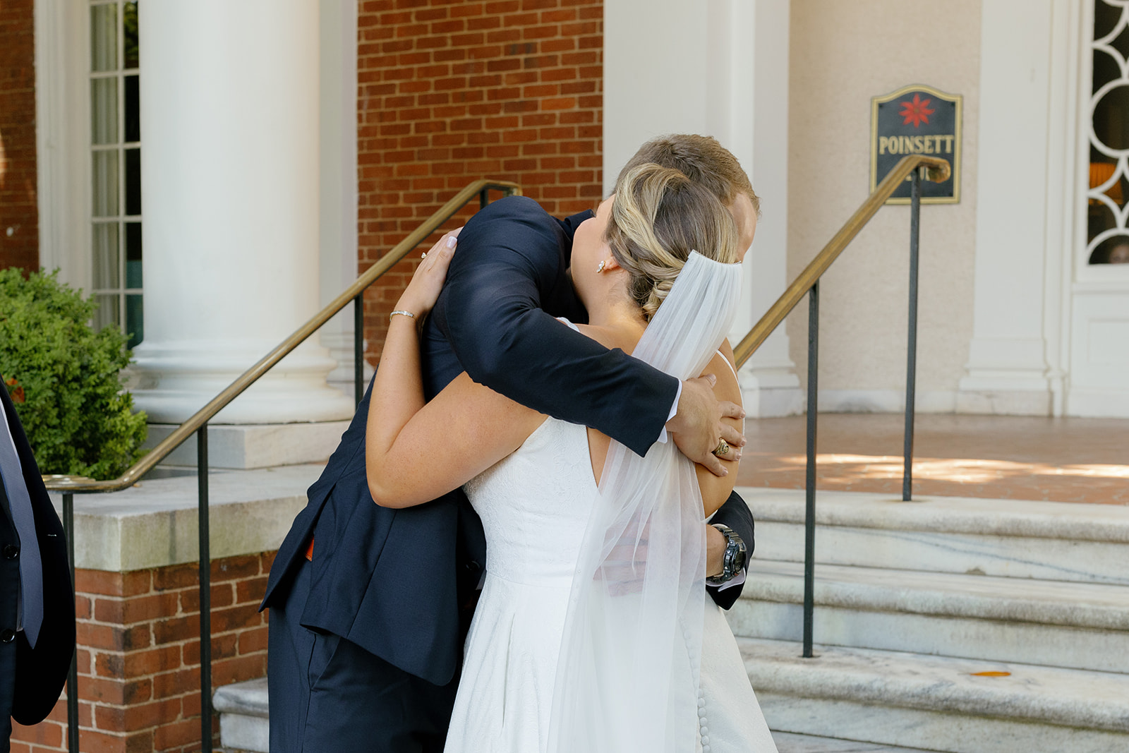 Bride embraces her father tightly during a heartfelt first look outside the venue.