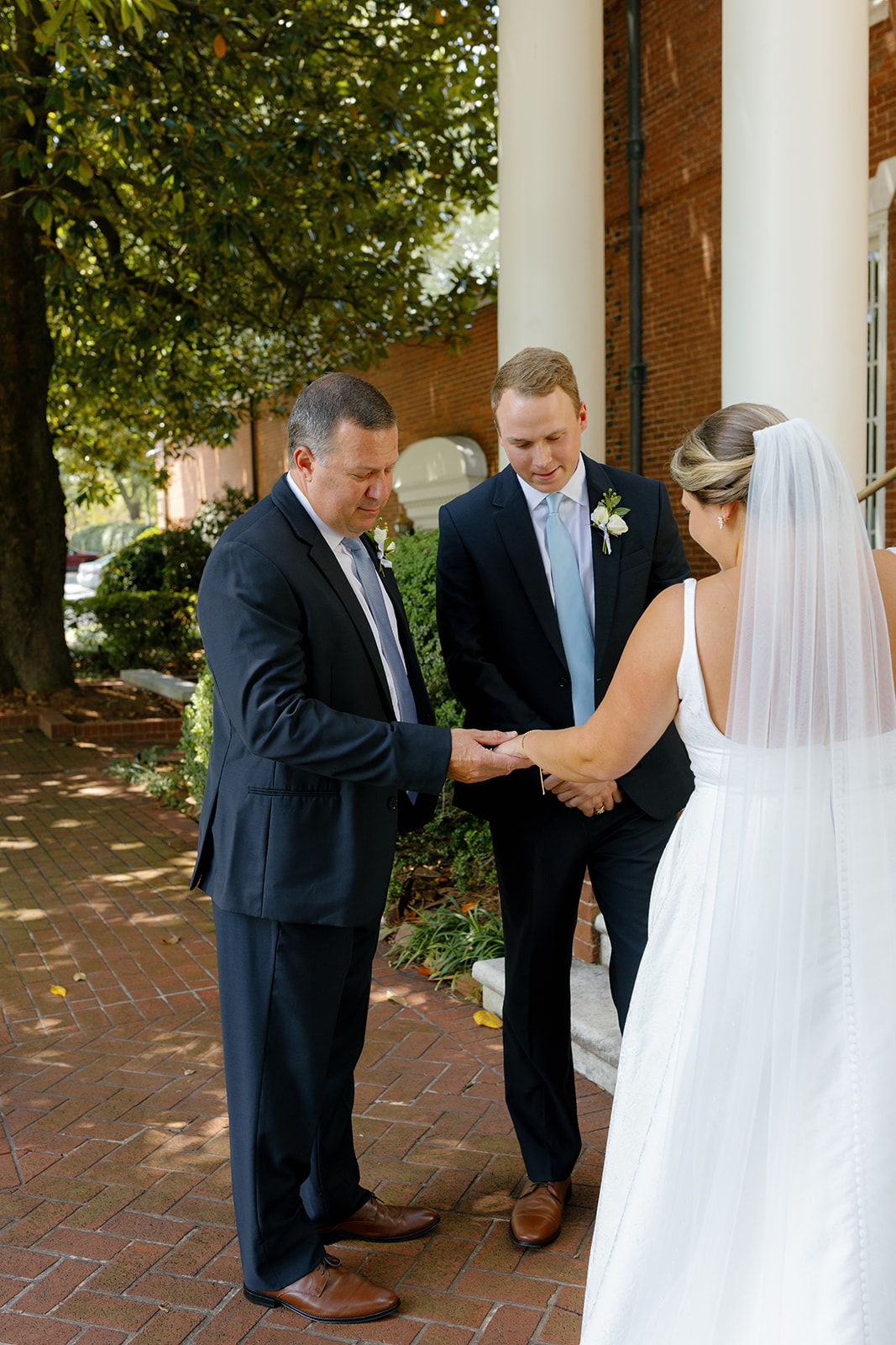 Bride shares a special bracelet with two family members during an intimate moment