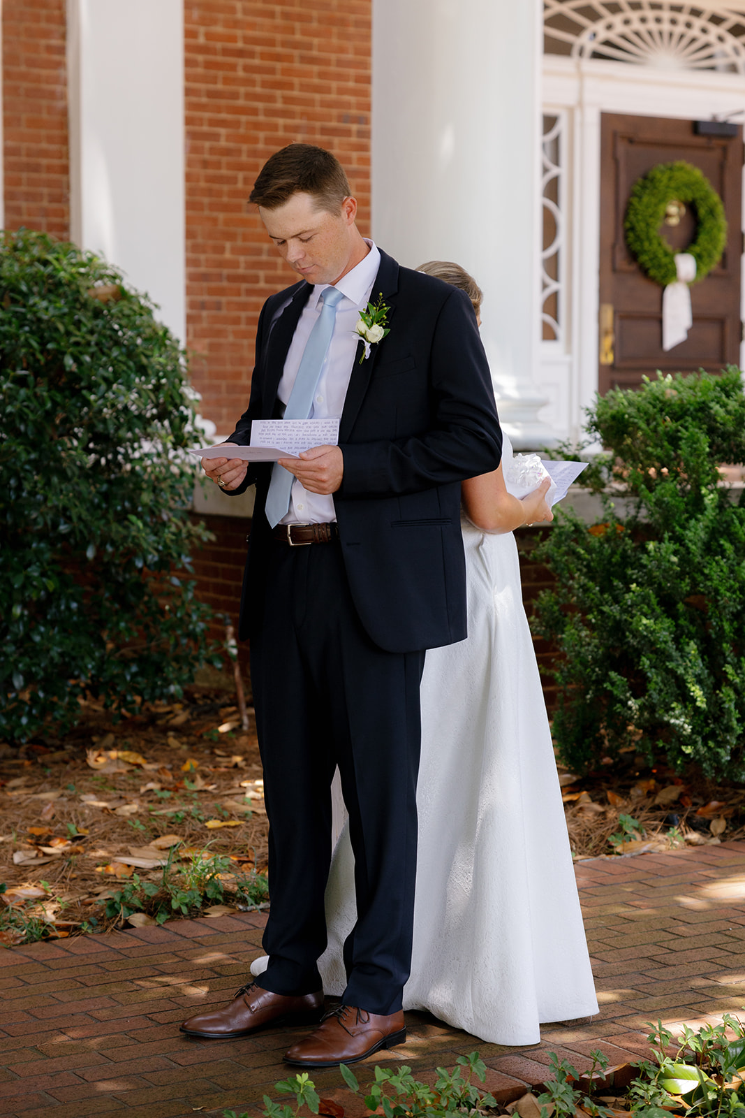 the couple share a private moment reading letters back-to-back outside the Poinsett Club.