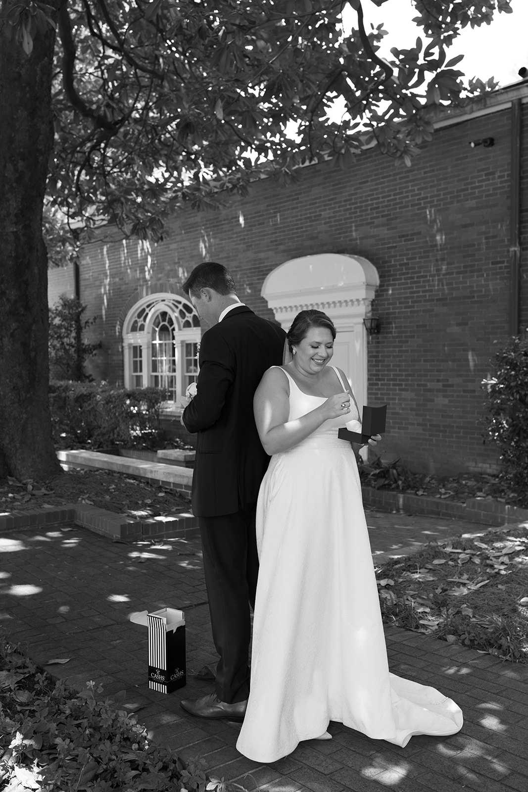 Bride beams as she opens a special gift from the groom during their emotional first touch moment.