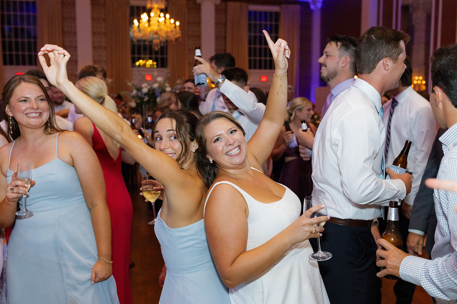 bride celebrates with bridesmaids at her reception