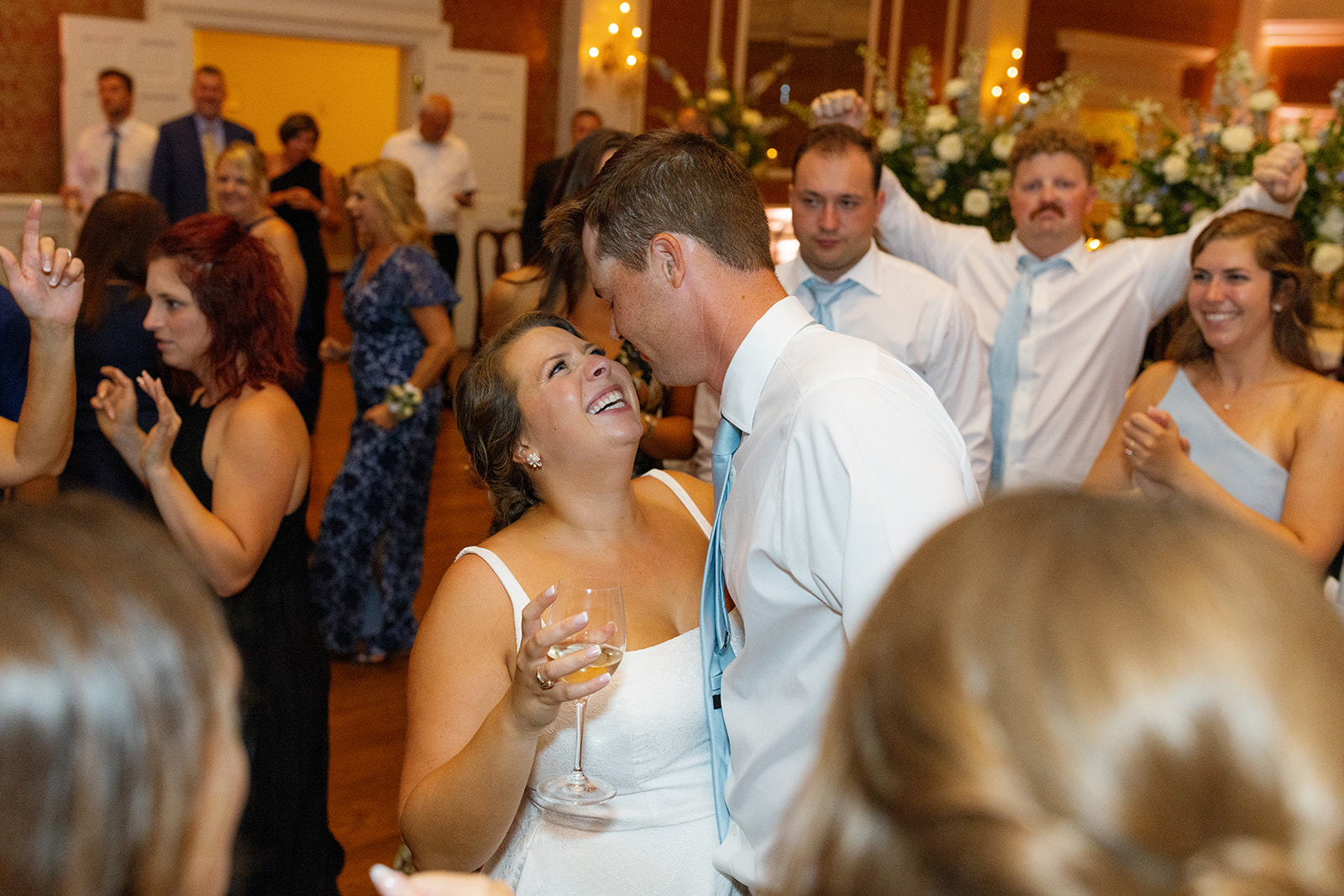 bride looks up at her groom lovingly at their reception 