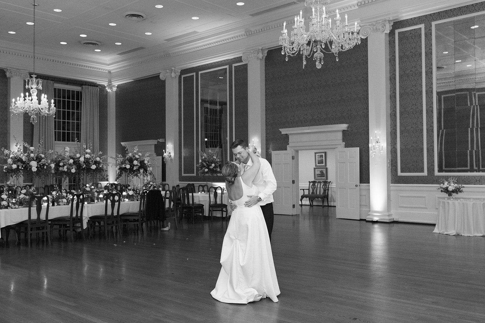 black and white of couple dancing at the end of their wedding
