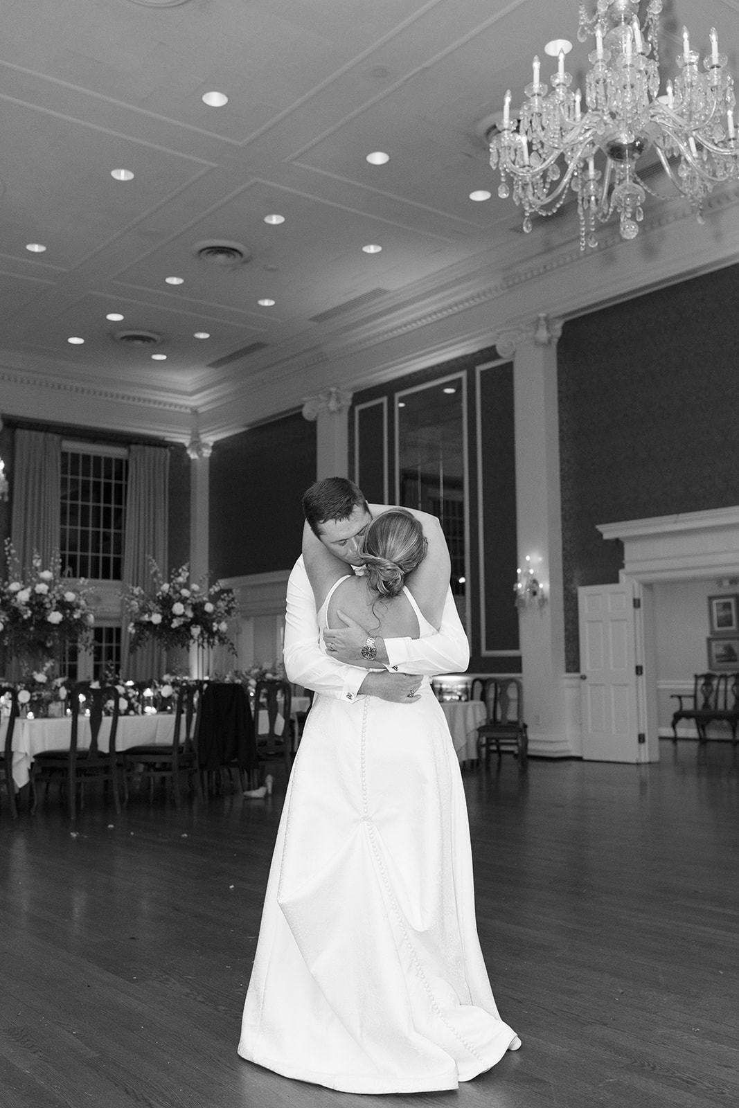 close-up black and white of newlyweds dancing at the end of their wedding