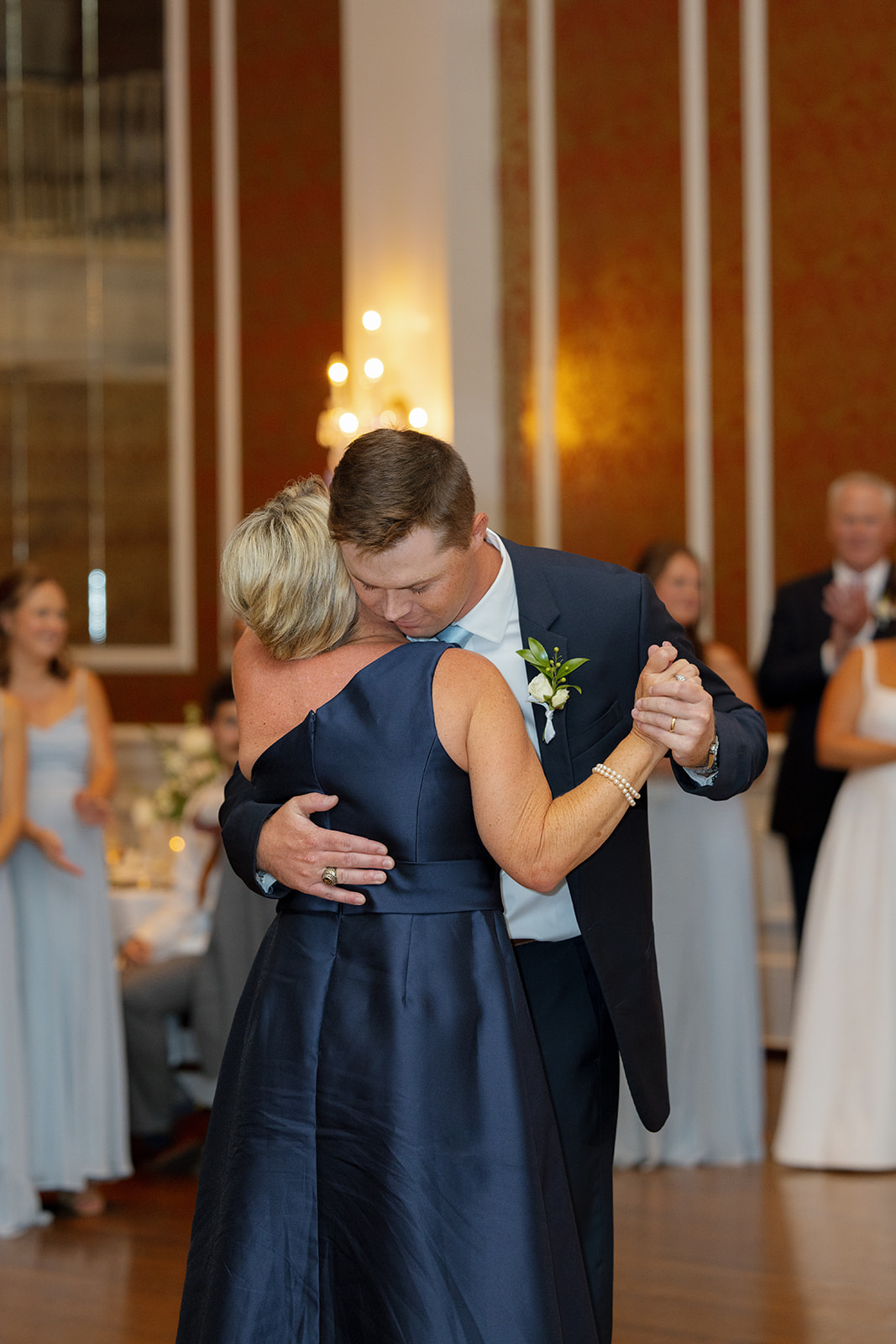 Groom embraces his mother during an emotional mother-son dance at the reception.