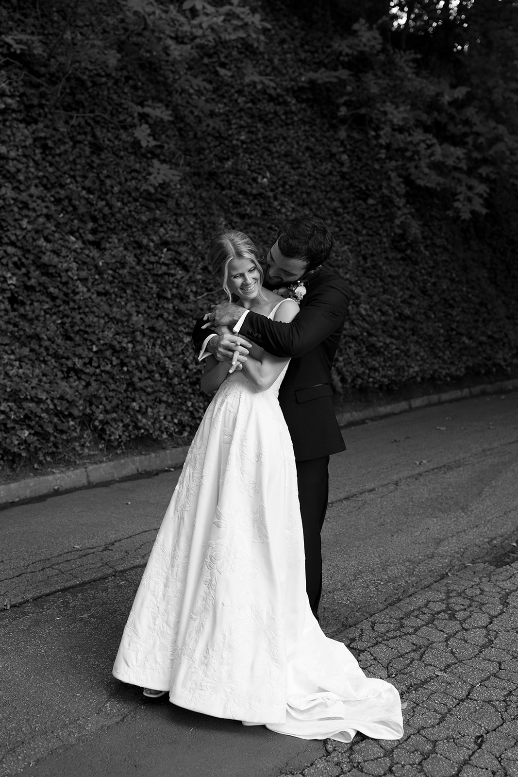 groom hugging bride from behind for a portrait 
