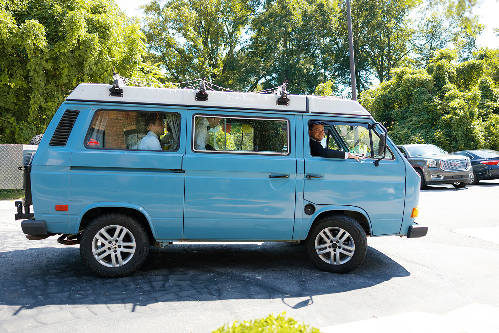the groom and groomsmen pulling up in his VW van