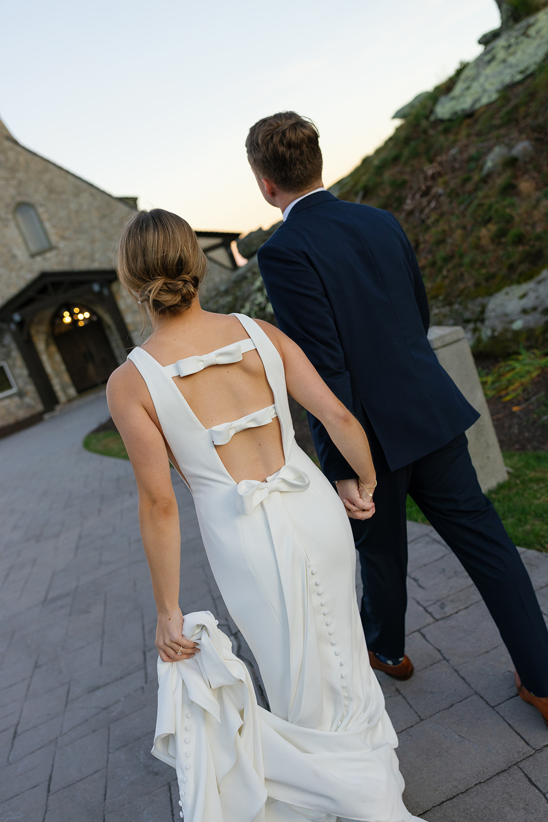 Bride and groom walk the path to the Cliffs at Glassy Chapel 