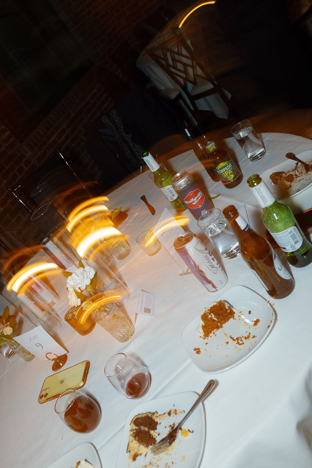 Empty dessert plates and drinks scatter a candlelit table after the reception at The L.
