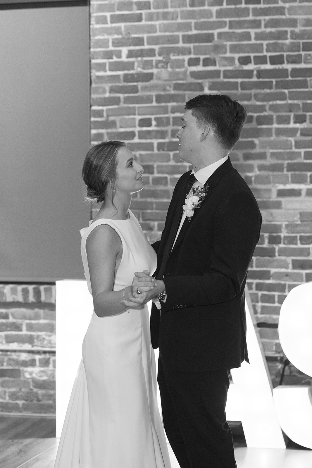 Bride and groom look lovingly at each other during their first dance