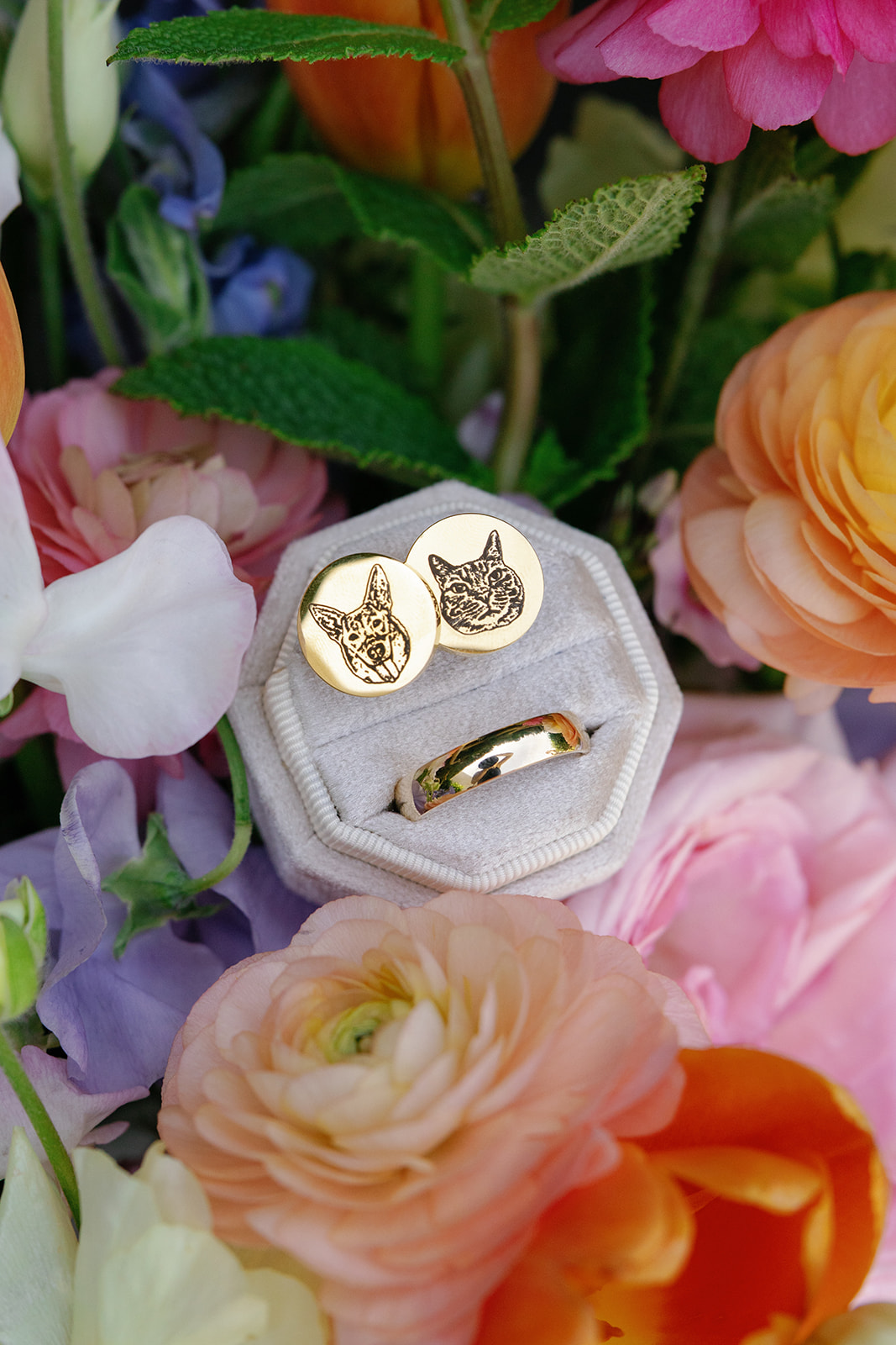 Custom gold cufflinks with pet engravings nestled in a bouquet of vibrant wedding florals taken by a Greenville SC Wedding Photographer..