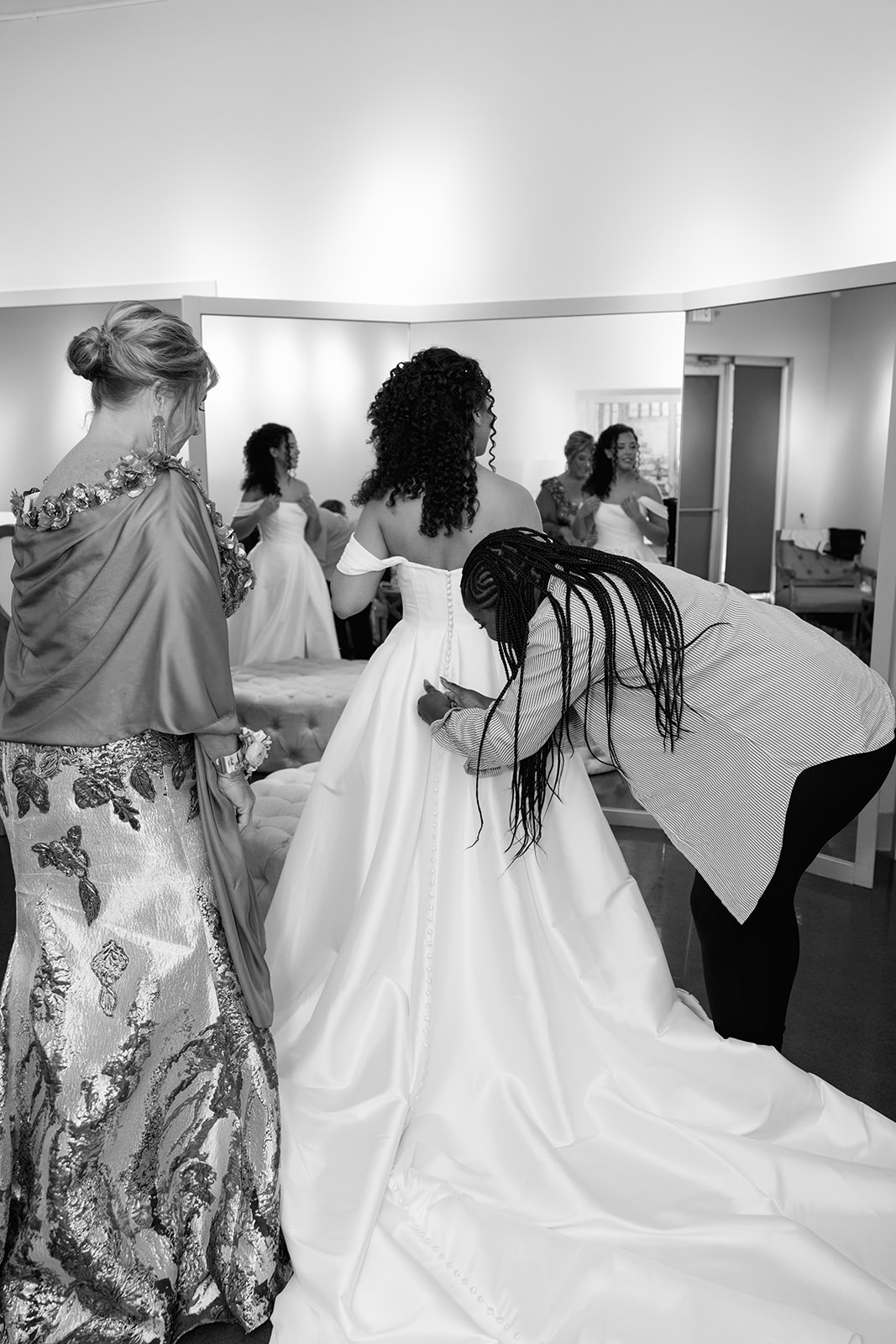 Black-and-white photo of the bride getting ready with her bridal party before the ceremony  taken by a Greenville SC Wedding Photographer.