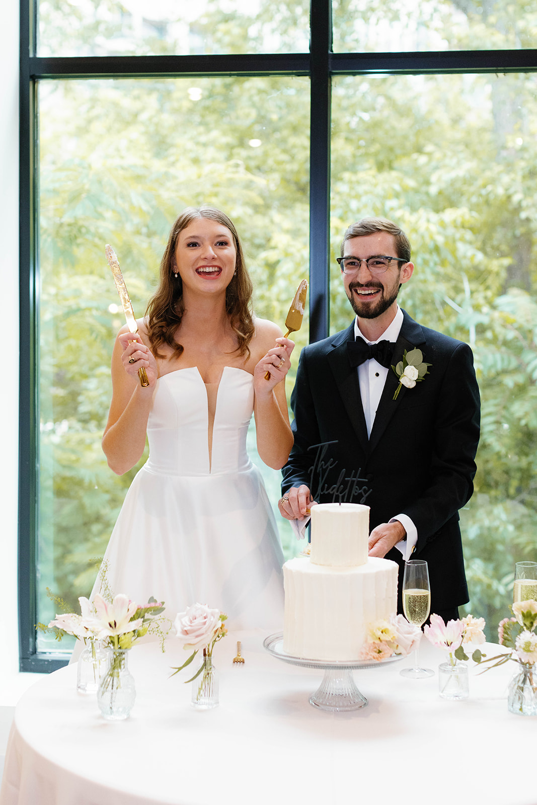 bride and groom cutting their wedding cake 