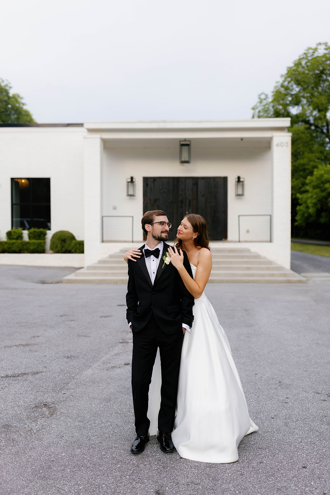 The couple shares a sweet moment outside The 405, a modern white venue in Greenville, South Carolina.