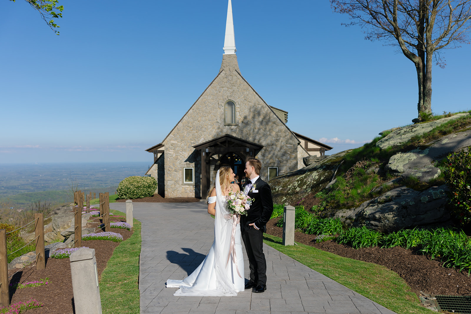 Bride and groom smile outside Glassy Chapel in SC