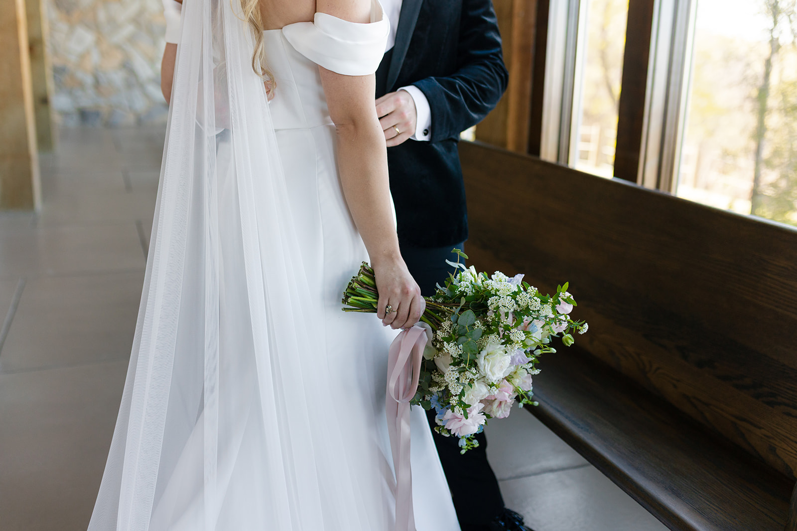closeup of bride and groom with beautiful floral boquet