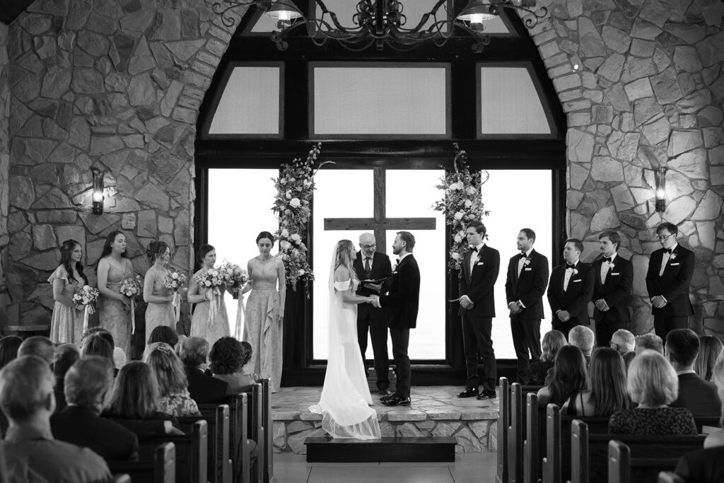 bride and groom with wedding party during ceremony