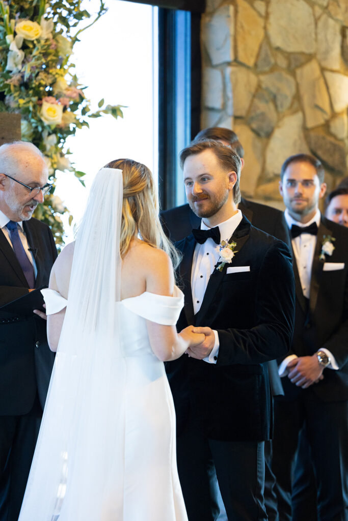 groom smiling at bride during wedding