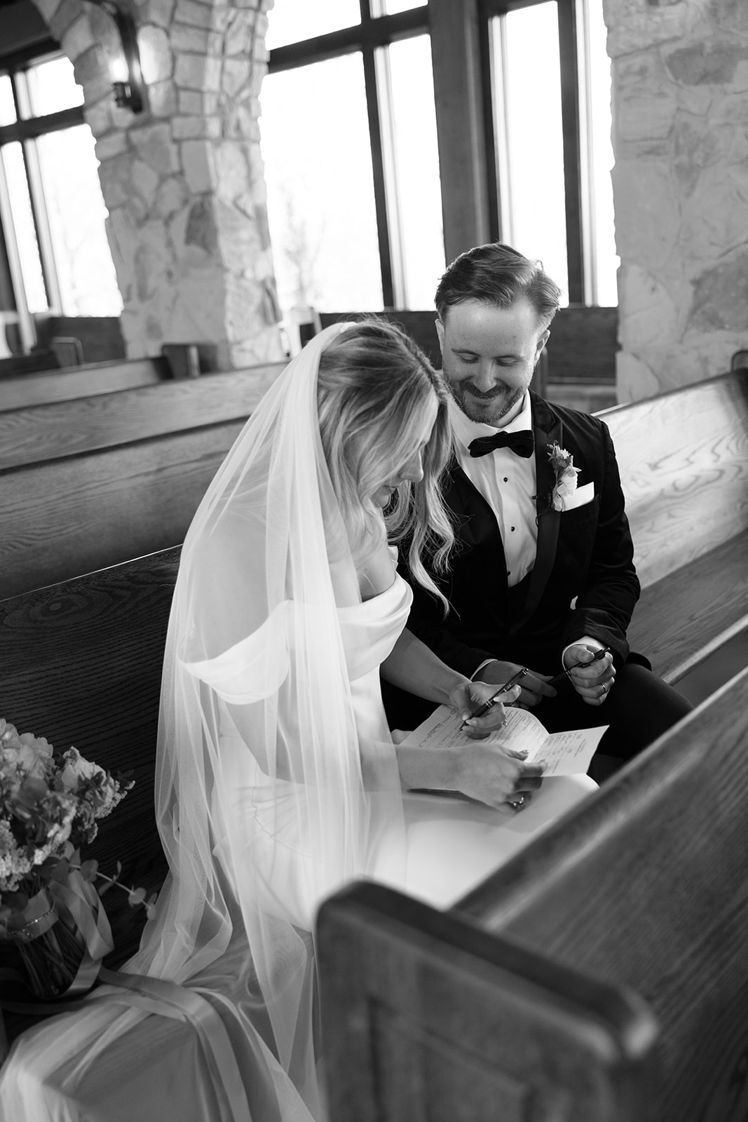 bride and groom signing their marriage certificate