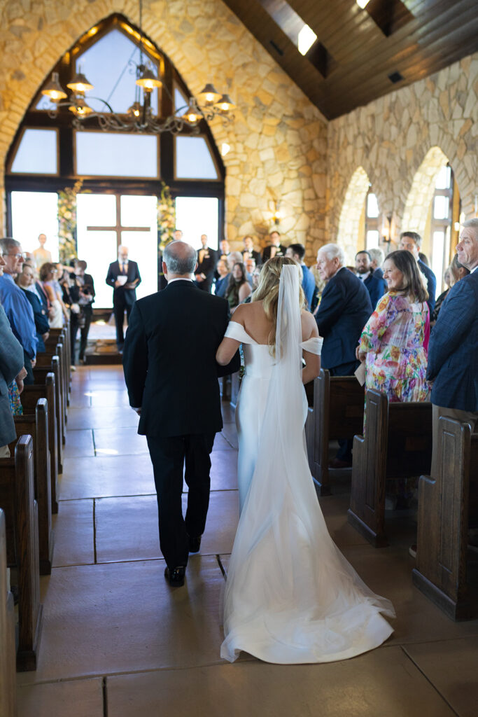 Bride and her father walk down the isle at the Glassy Chapel in SC