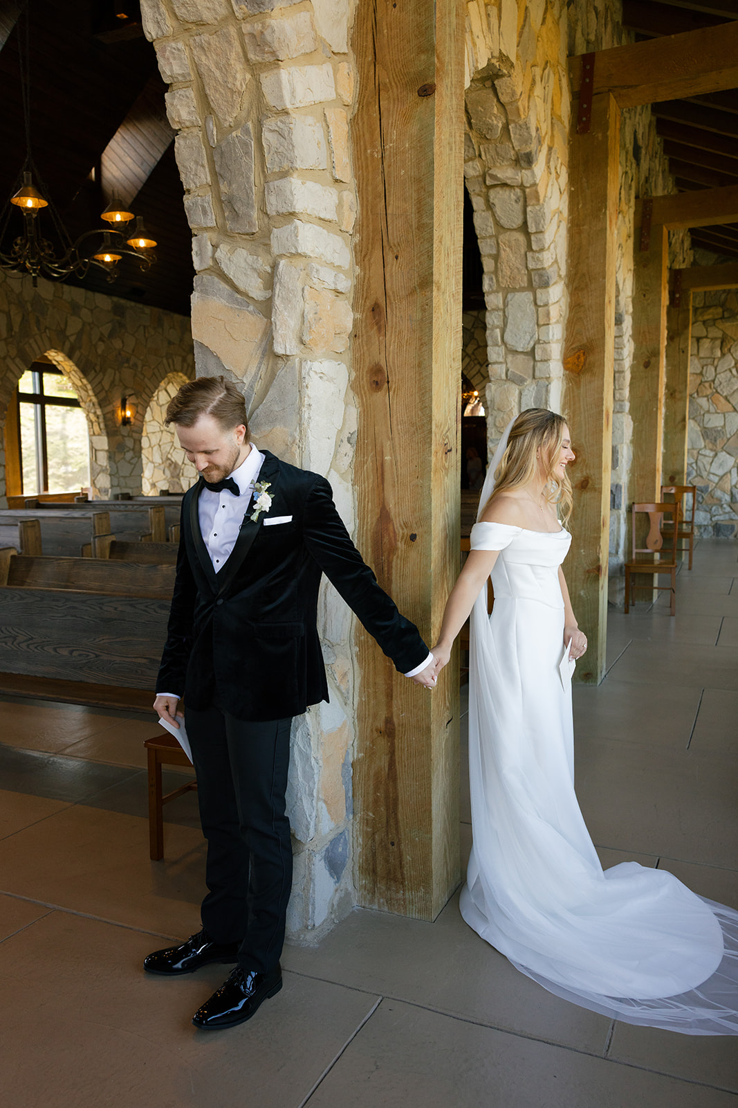 bride and groom during their first touch at Glassy Chapel