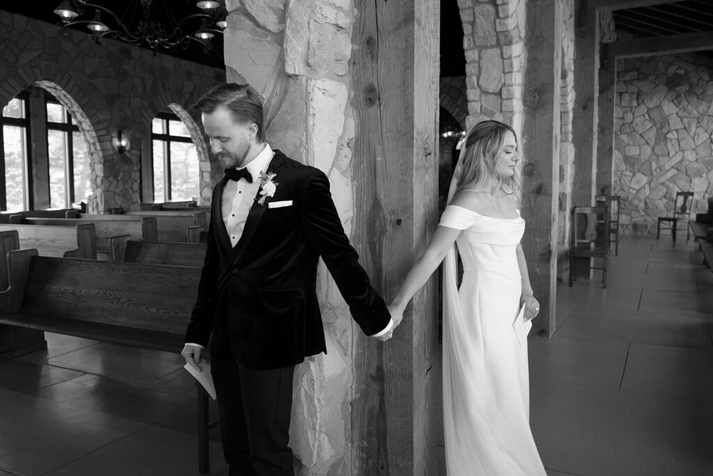 black and white of bride and groom's first touch in South Carolina