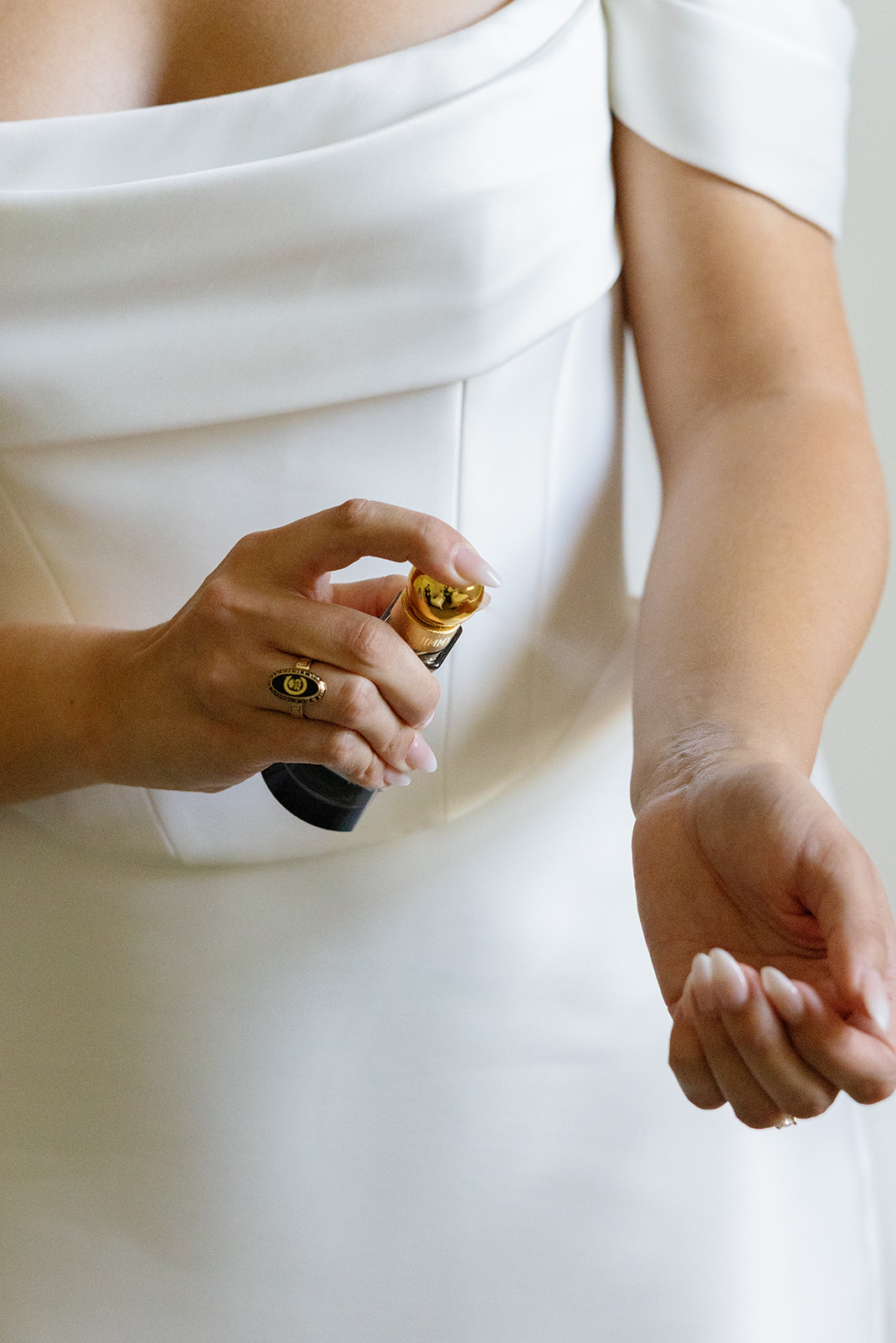 bride spraying her wrist with perfume captured by a wedding photographer in South Carolina