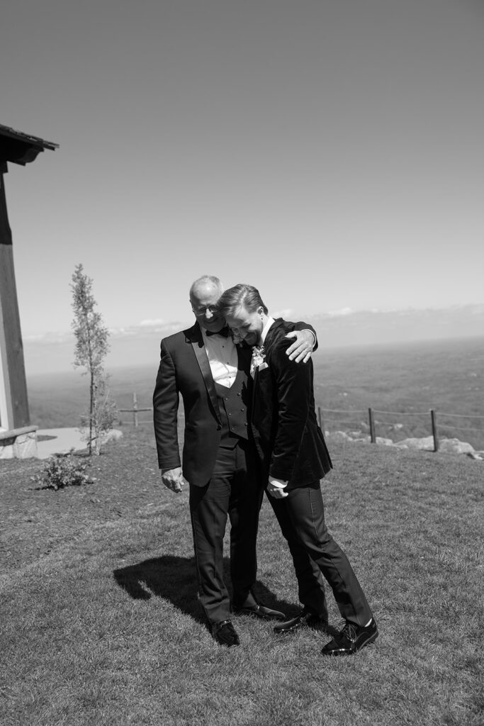 groom shares a hug with his father