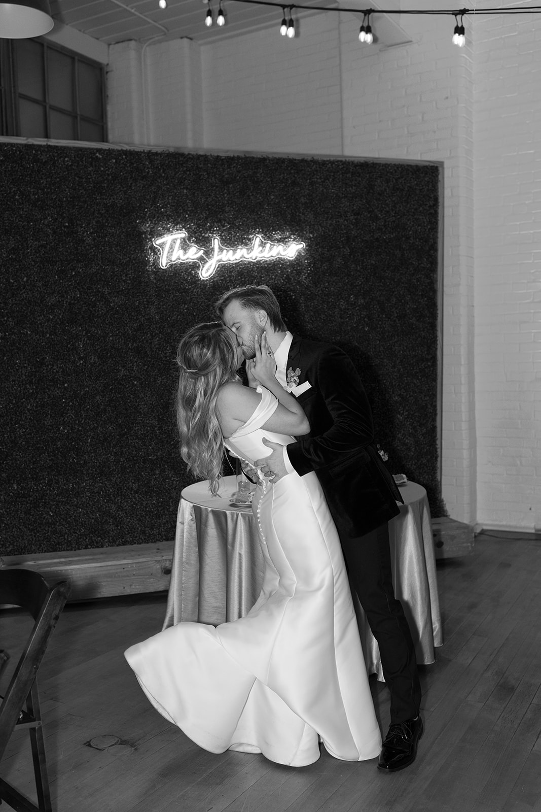 bride lifts foot while kissing her new husband at their wedding in South Carolina