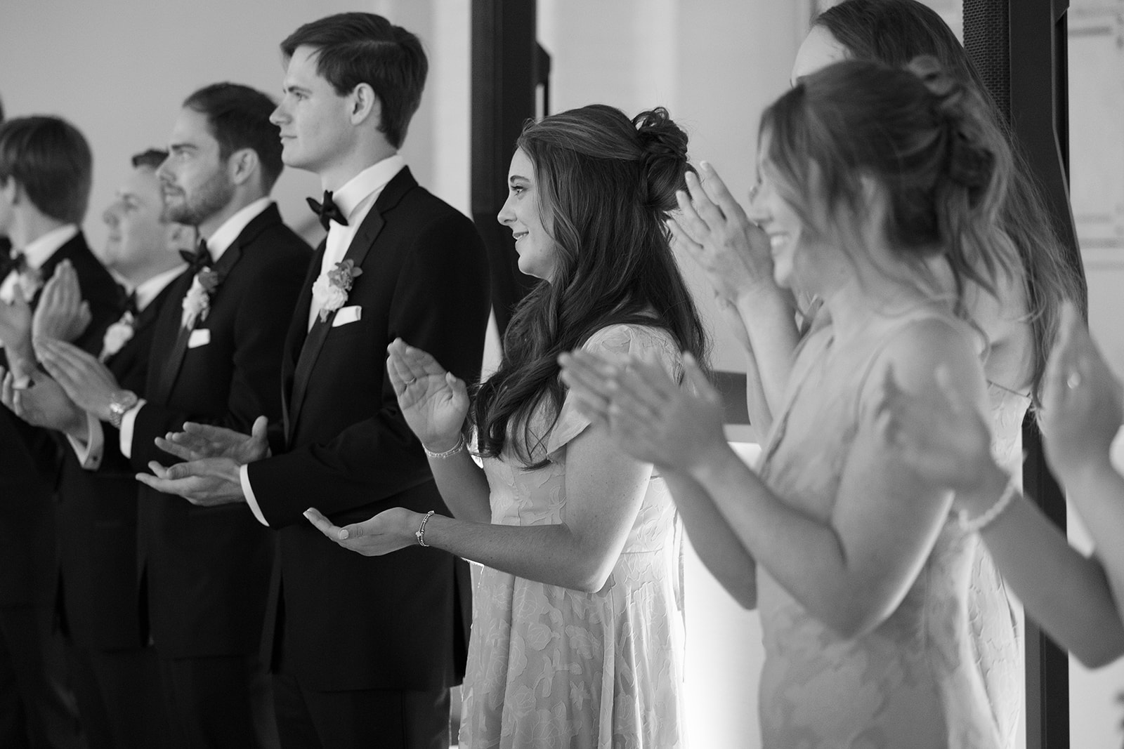 wedding guests clap as bride and groom makes their entrance