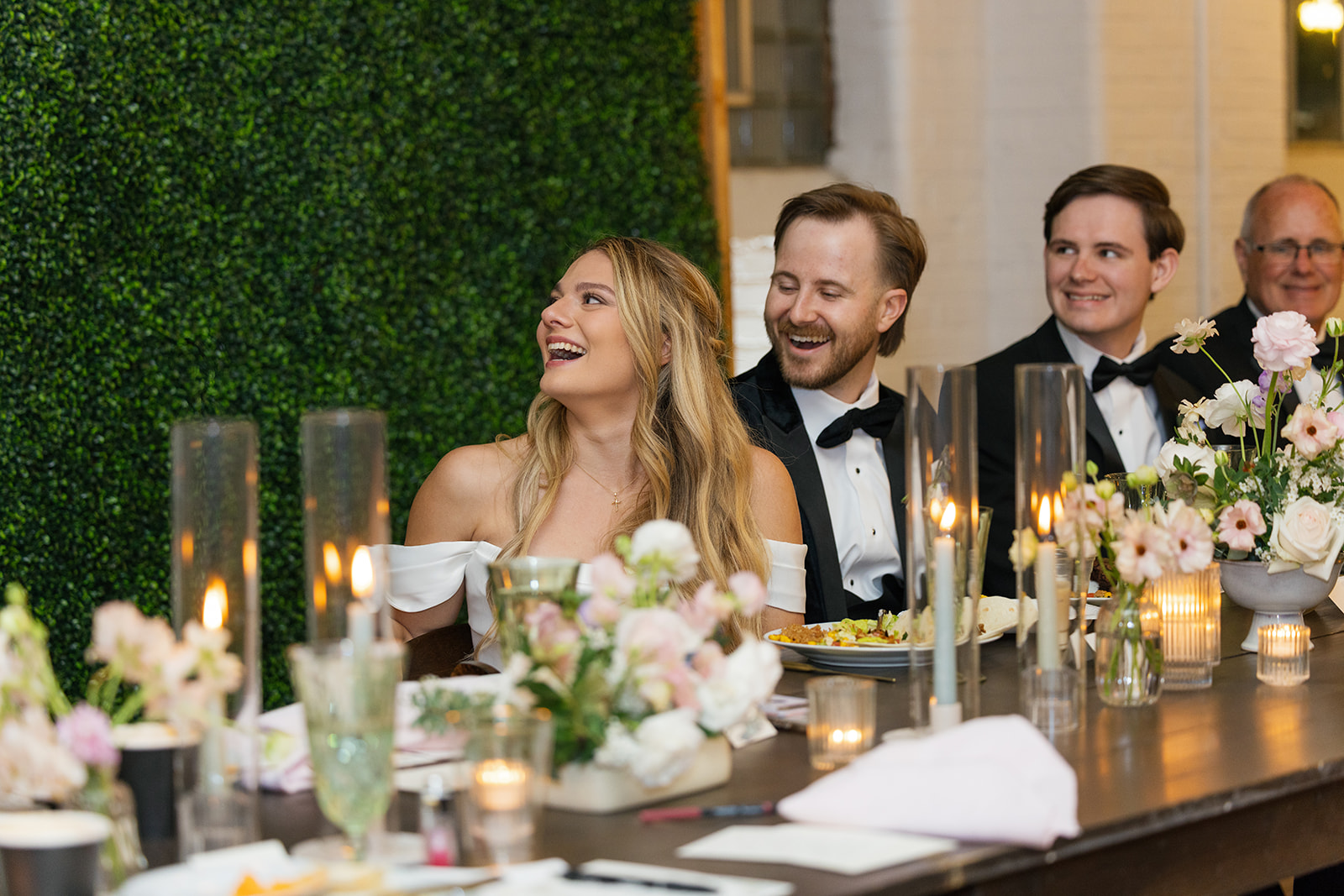 bride and groom laughing at speeches given at their wedding reception at Southern Bleachery.