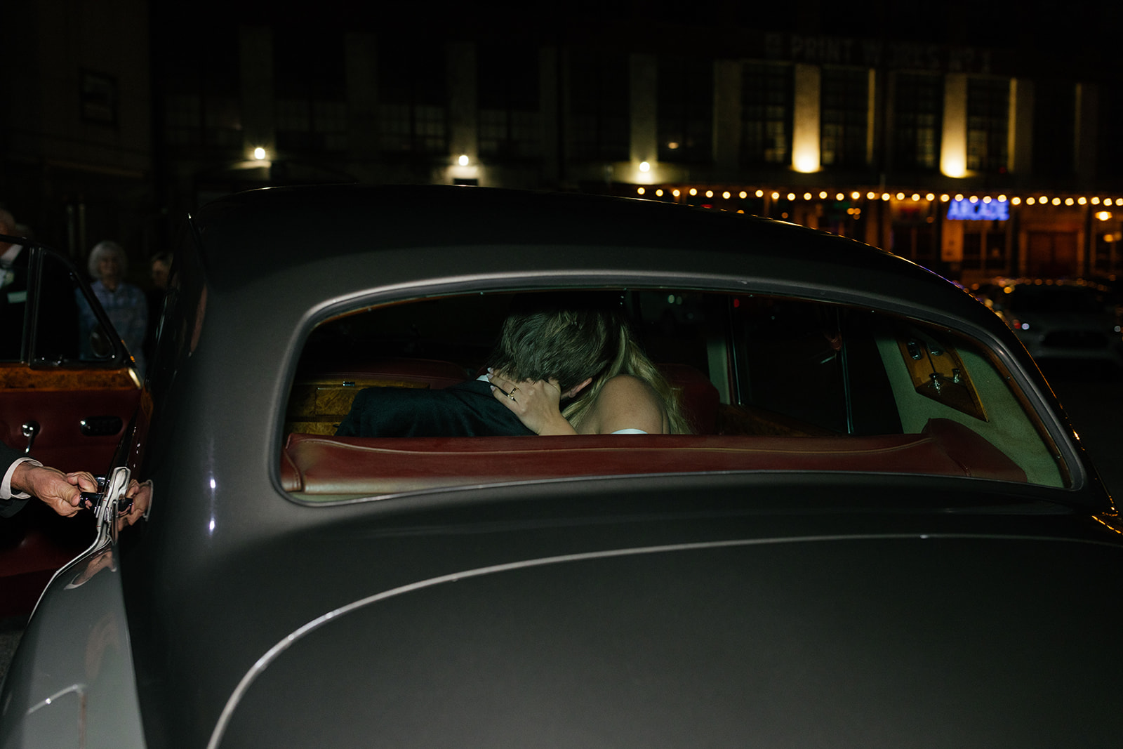 bride and groom kissing in their getaway car taken by a wedding photographer in South Carolina.