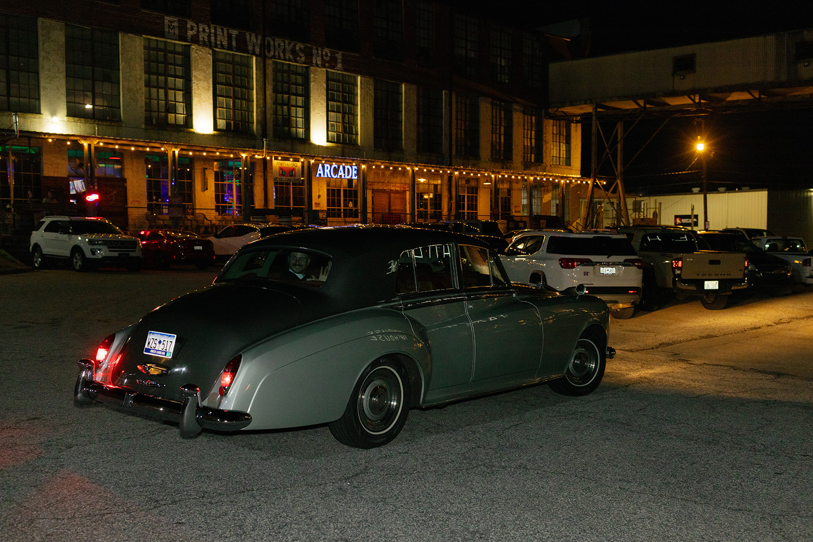 bride and groom driving off in their getaway car taken by a wedding photographer in South Carolina.