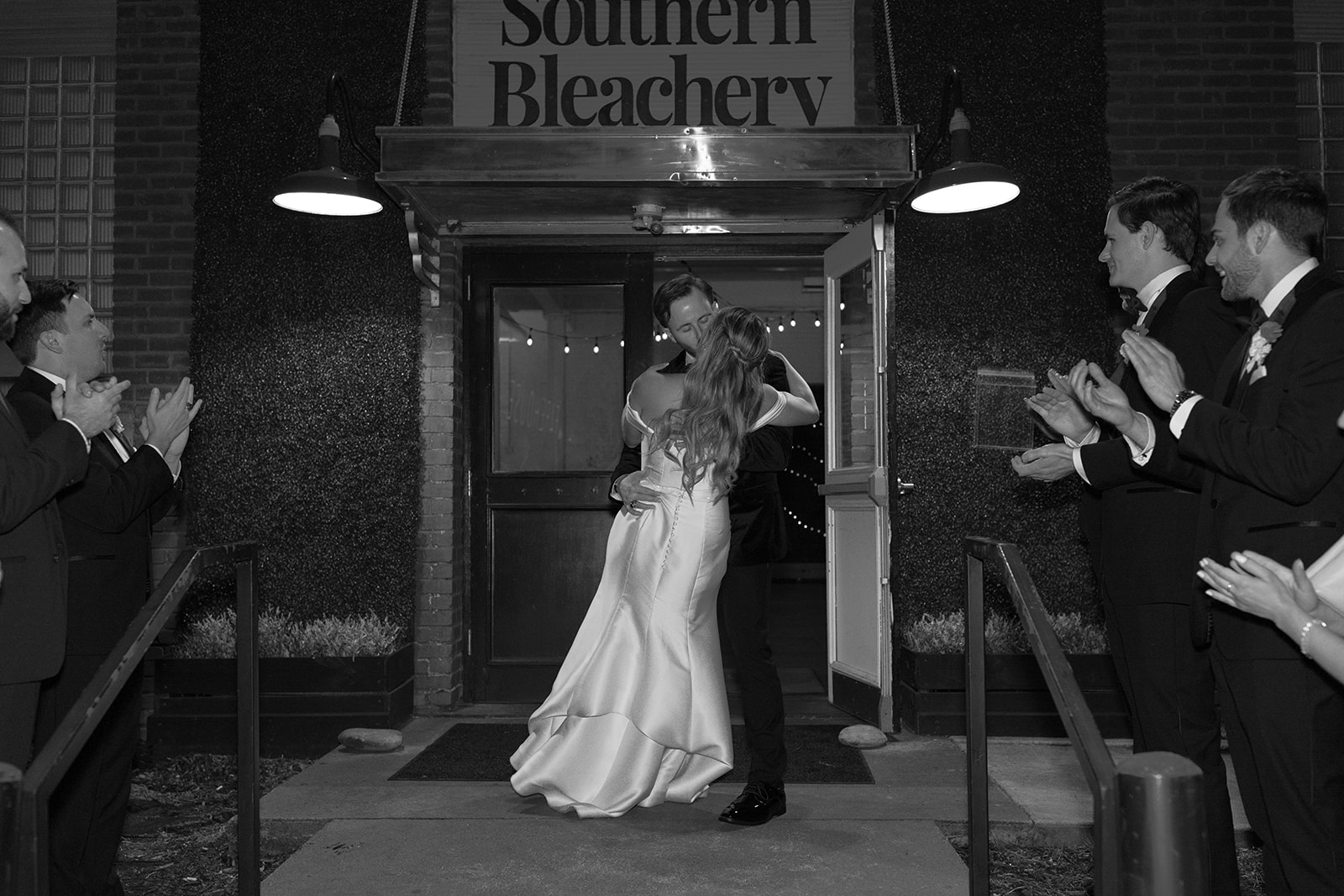 bride and groom share a romantic kiss as they leave their reception on SC