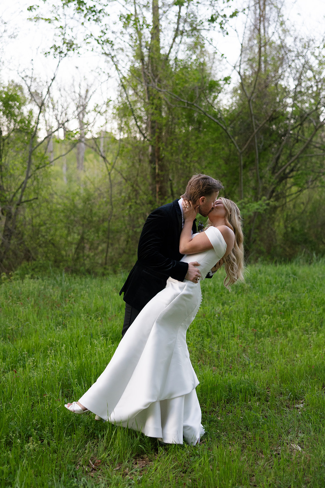 groom dipping and kissing the bride 