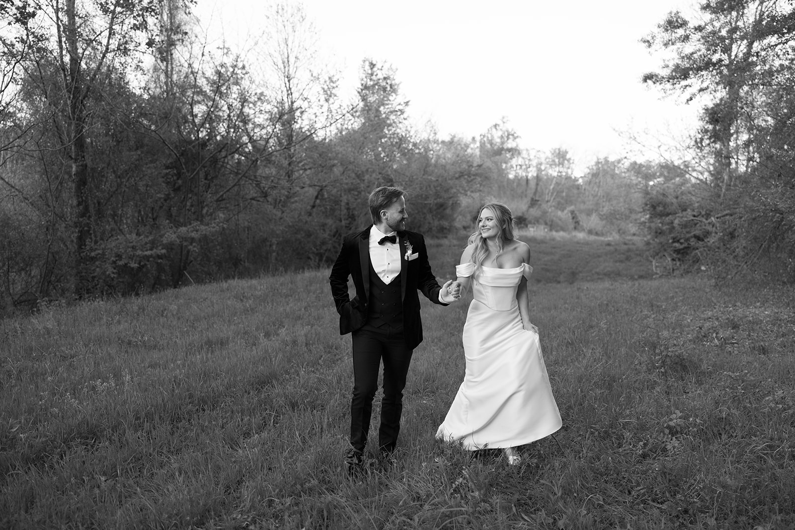bridal couple walking together for sunset portraits 