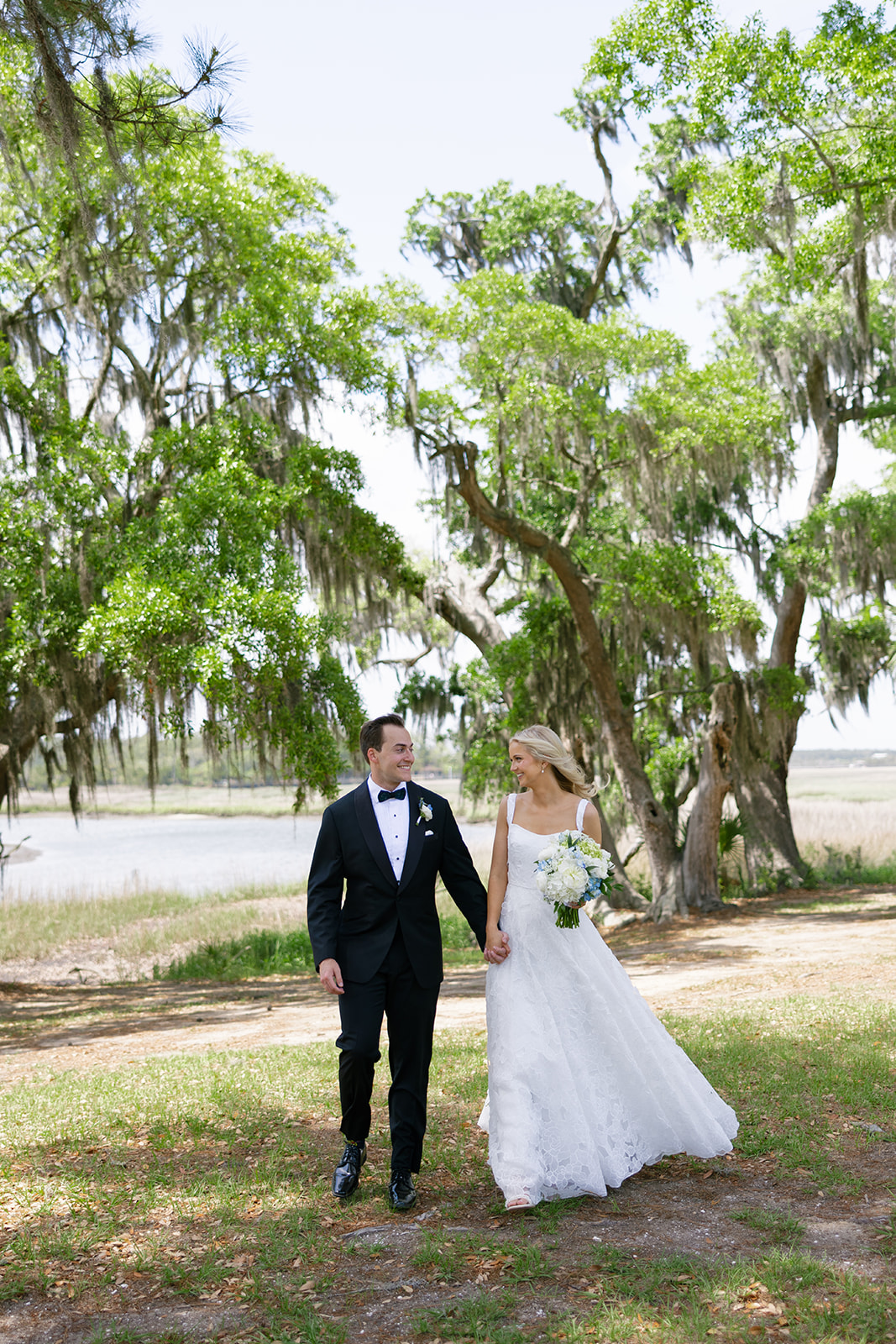 bride and groom under the Avenue of Oaks